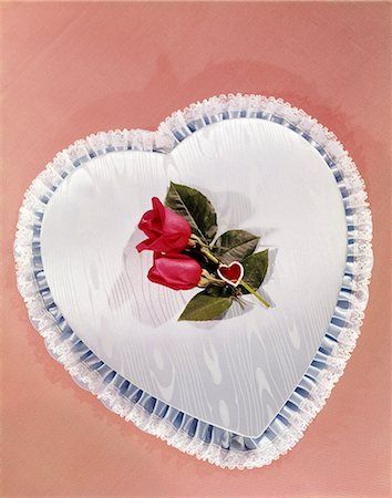 1950s 1960s HEART SHAPED BOX COVERED WITH BLUE SATIN LACE TRIM TWO RED ROSES VALENTINE ROMANCE Stock Photo - Rights-Managed, Code: 846-03166145