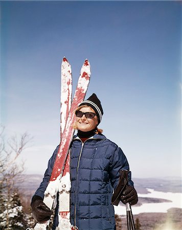 simsearch:846-02797740,k - 1960s PORTRAIT SMILING WOMAN OUTDOORS WEARING QUILTED DOWN JACKET SUNGLASSES HOLDING SKIS Stock Photo - Rights-Managed, Code: 846-03166170