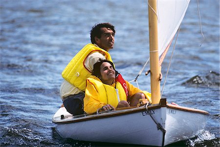 retro sail - 1980s MAN AND WOMAN CREW SAILING A MELON SEED SKIFF ON RIVER Stock Photo - Rights-Managed, Code: 846-03166238