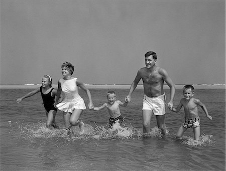 siblings bathing - 1960s FAMILY HOLDING HANDS RUNNING IN WATER AT OCEAN BEACH Stock Photo - Rights-Managed, Code: 846-03163207