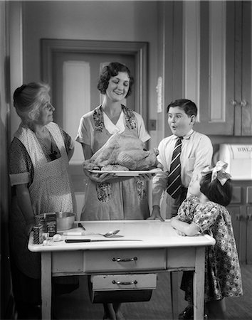 elder woman table - 1920s 1930s MOTHER GRANDMOTHER BOY GIRL COOKING TURKEY IN KITCHEN Stock Photo - Rights-Managed, Code: 846-03163344