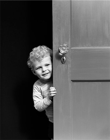 1940s CHILD PEERING LOOKING AROUND DOOR Stock Photo - Rights-Managed, Code: 846-03163615