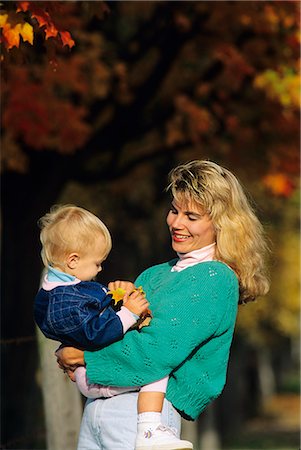 MOTHER AND SMALL CHILD WITH FALL LEAVES IN BACKGROUND Stock Photo - Rights-Managed, Code: 846-03163795