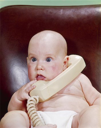 1960s CHUBBY BABY LEATHER CHAIR TALKING ON TELEPHONE Stock Photo - Rights-Managed, Code: 846-03163924