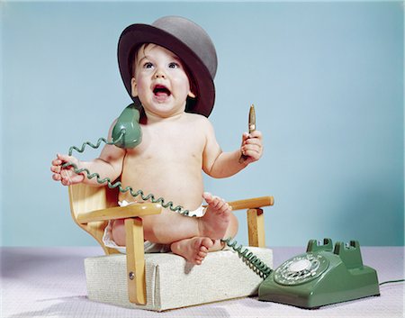 1960s BABY BOY SITTING BOOSTER CHAIR HOLDING CIGAR WEARING HAT HOLDING TELEPHONE Stock Photo - Rights-Managed, Code: 846-03163956