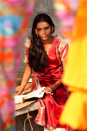 Student girl, sitting behind bright coloured silks, Kerala, India, Asia Stock Photo - Rights-Managed, Code: 841-05786034