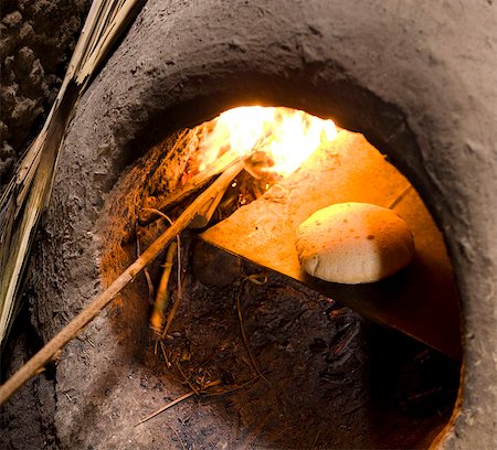 Freshly-baked bread in a traditional communal clay oven in the town of Merzouga, Morocco, North Africa, Africa Stock Photo - Rights-Managed, Code: 841-05781346