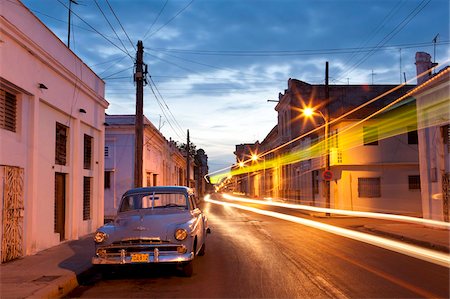 street scene night - Street scene at night showing Classic American car and the light trails of passing traffic, Cienfuegos, Cuba, West Indies, Central America Stock Photo - Rights-Managed, Code: 841-05781387
