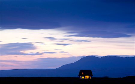 daylit - Twilight view towards mountains with small house illuminated by interior lights, near Hella, South West Iceland, Iceland, Polar Regions Stock Photo - Rights-Managed, Code: 841-05781444