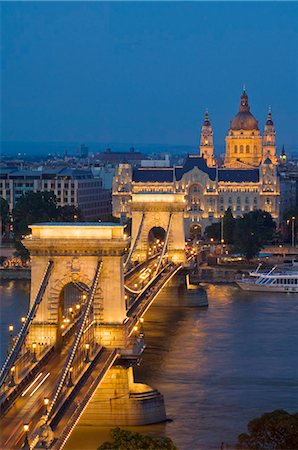 pest - Night view of the Chain Bridge (Szechenyi Lanchid), illuminated, over the River Danube with the Gresham Hotel, St. Stephen's basilica, and the Pest side behind, Budapest, Hungary, Europe Stock Photo - Rights-Managed, Code: 841-05782297