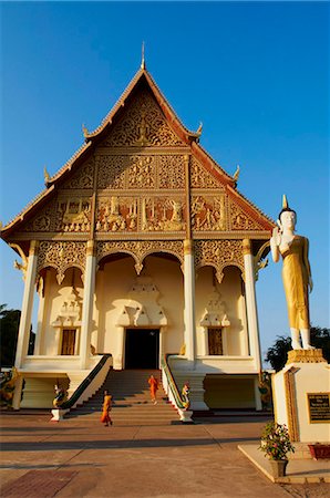 simsearch:841-06501931,k - Statue of standing Buddha and monks, Pha That Luang temple, Vientiane, Laos, Indochina, Southeast Asia, Asia Stock Photo - Rights-Managed, Code: 841-05796452