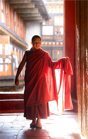 Young Buddhist monk in red robes backlit by evening sunlight at the Jakar Dzong, Jakar, Bumthang, Bhutan, Asia Stock Photo - Rights-Managed, Code: 841-05845859