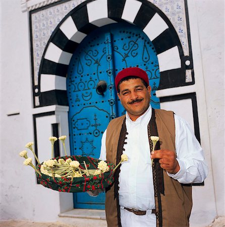 Jasmine seller in doorway, Sidi Bou Said, Tunisia, North Africa, Africa Stock Photo - Rights-Managed, Code: 841-05848767