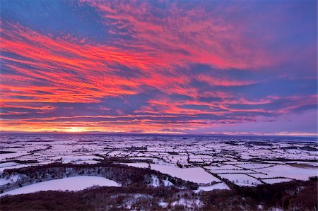 Fiery sunset over a snow covered Gormire Lake from Sutton Bank on the edge of the North Yorkshire Moors, Yorkshire, England, United Kingdom, Europe Stock Photo - Rights-Managed, Code: 841-05848824