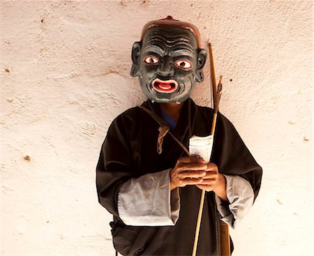 Monk dressed as a clown and wearing carved wooden mask collecting money from spectators at the Wangdue Phodrang Tsechu, Wangdue Phodrang Dzong, Wangdue Phodrang (Wangdi), Bhutan, Asia Stock Photo - Rights-Managed, Code: 841-05959770