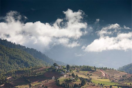 simsearch:841-06446529,k - Village of Shingyer against a dramatic backdrop of mountains and clouds, Phobjikha Valley, Bhutan, Himalayas, Asia Stock Photo - Rights-Managed, Code: 841-05959797