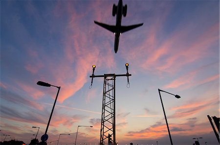 DC9 aircraft approaching over runway landing light gantries at sunset, London, England, United Kingdom, Europe Stock Photo - Rights-Managed, Code: 841-06030345