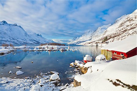 Snow covered mountains, boathouse and moorings in Norwegian fjord village of Ersfjord, Kvaloya island, Troms, Norway, Scandinavia, Europe Stock Photo - Rights-Managed, Code: 841-06030761