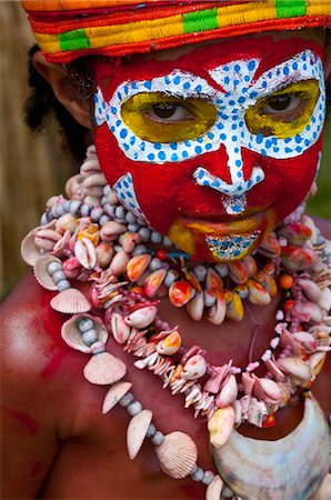 Colourfully dressed and face painted local child celebrating the traditional Sing Sing in the Highlands of Papua New Guinea, Pacific Stock Photo - Rights-Managed, Code: 841-06344098