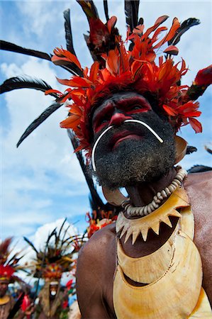 Colourfully dressed and face painted local tribesman celebrating the traditional Sing Sing in the Highlands of Papua New Guinea, Pacific Stock Photo - Rights-Managed, Code: 841-06344106