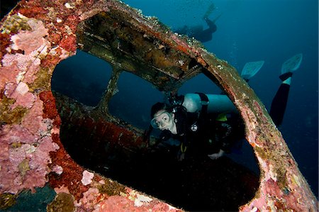 female scuba diver - Diver entering the front window of a four seater plane wreck, Philippines, Southeast Asia, Asia Stock Photo - Rights-Managed, Code: 841-06340930