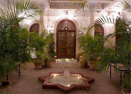 fountain - An interior courtyard featuring a marble fountain and palm trees at the Villa des Orangiers in Marrakech, Morocco, North Africa, Africa Stock Photo - Rights-Managed, Code: 841-06341303