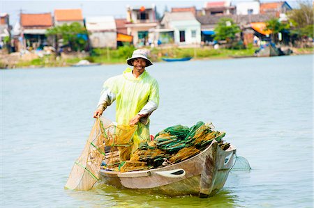 Man fishing from his boat at the old port town of Hoi An, Vietnam, Indochina, Southeast Asia, Asia Stock Photo - Rights-Managed, Code: 841-06445105