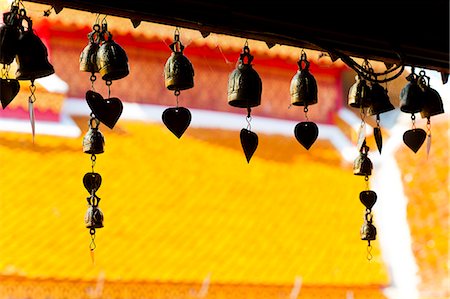 Close up of prayer bells, silhouetted against the colourful roof at Wat Doi Suthep, Chiang Mai, Thailand, Southeast Asia, Asia Stock Photo - Rights-Managed, Code: 841-06445177