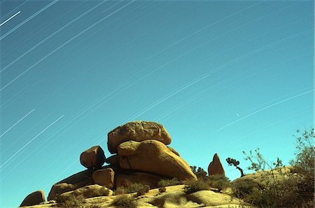 star trails - Time exposure of stars streaking across the sky with rock formations in the foreground, Joshua Tree National Park, California, United States of America, North America Stock Photo - Rights-Managed, Code: 841-06446521