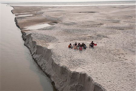 Villagers stopping to eat near the fragile edge of a sandspit in the River Ganges, Sonepur, Bihar, India, Asia Stock Photo - Rights-Managed, Code: 841-06447653