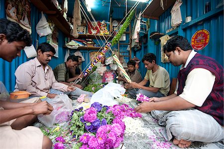 Mala makers (garland makers) at work in Kolkata's morning flower market, Howrah, Kolkata, West Bengal, India, Asia Stock Photo - Rights-Managed, Code: 841-06447758