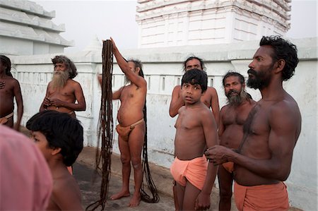 strange people hair - A devout Joranda monk gathers his uncut hair to coil it on top of his head, surrounded by other monks, Joranda, Dhenkanal, Orissa, India, Asia Stock Photo - Rights-Managed, Code: 841-06447802