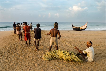 Fishermen hauling in nets at sunrise, Chowara Beach, near Kovalam, Kerala, India, Asia Stock Photo - Rights-Managed, Code: 841-06449419
