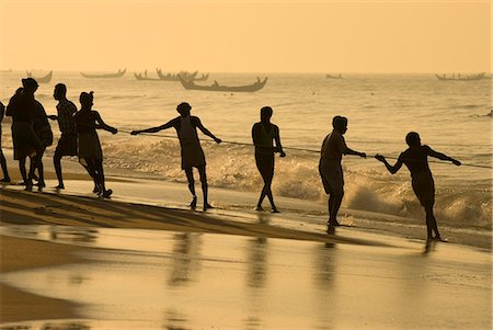 Fishermen hauling in nets at sunrise, Chowara Beach, near Kovalam, Kerala, India, Asia Stock Photo - Rights-Managed, Code: 841-06449421