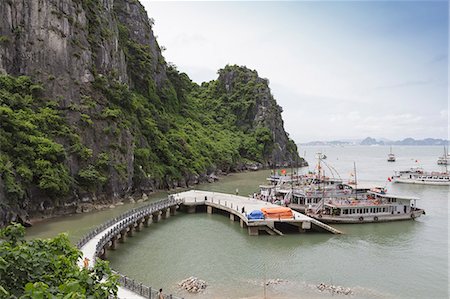 simsearch:841-02899056,k - A boat docking station at one of the many isalnds in Ha Long Bay, UNESCO World Heritage Site, Vietnam, Indochina, Southeast Asia, Asia Stock Photo - Rights-Managed, Code: 841-06499234