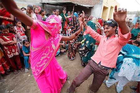 Dancing in the street during Holi celebration in Goverdan, Uttar Pradesh, India, Asia Stock Photo - Rights-Managed, Code: 841-06502161