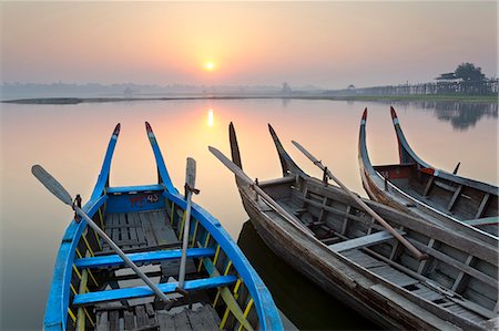 simsearch:841-06034119,k - Traditional rowing boat moored on the edge of flat calm Taungthaman Lake at dawn with the colours of the sky reflecting in the calm water, close to the famous U Bein teak bridge, near Mandalay, Myanmar (Burma), Asia Stock Photo - Rights-Managed, Code: 841-07081638