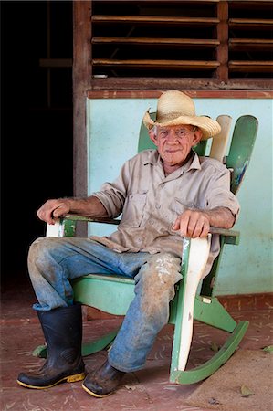 simsearch:841-07081838,k - Tobacco farmer wearing straw hat and Wellington boots, on a rocking chair outside his house, Vinales, Pinar Del Rio, Cuba, West Indies, Central America Stock Photo - Rights-Managed, Code: 841-07081821