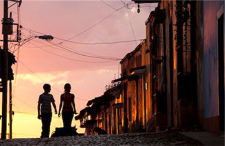 simsearch:841-07081838,k - Two young people in silhouette at sunset on cobbled street with colourful orange sky behind, Trinidad, UNESCO World Heritage Site, Cuba, West Indies, Central America Stock Photo - Rights-Managed, Code: 841-07081836