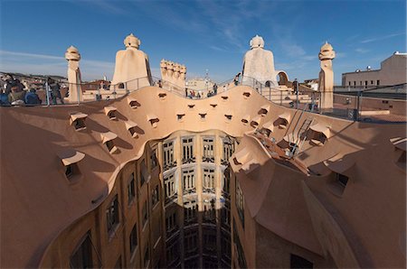 Upper floor and roof chimneys of the apartment building designed by Antonio Gaudi, La Pedrera (Casa Mila), UNESCO World Heritage Site, Passeig de Gracia, Barcelona, Catalonya, Spain Stock Photo - Rights-Managed, Code: 841-07082421