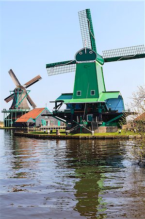 simsearch:841-03517157,k - Preserved historic windmills and houses in Zaanse Schans, a village on the banks of the river Zaan, near Amsterdam, it is a popular tourist attraction and working museum, Zaandam, North Holland, Netherlands Stock Photo - Rights-Managed, Code: 841-07205872