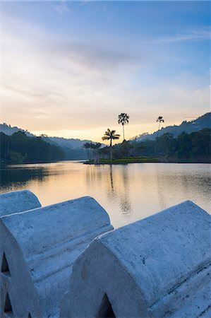 Kandy Lake at sunrise, the island of the Royal Summer House, with the Clouds Wall in the foreground, Kandy, Sri Lanka, Asia Stock Photo - Rights-Managed, Code: 841-07201406