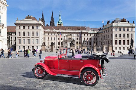 Red Oldtimer for tourist sightseeing tours in front of the First courtyard, Hradcany Square, Castle Hradcany and St Vitus cathedral, Castle District, UNESCO World Heritage Site, Prague, Bohemia, Czech Republic, europe Stock Photo - Rights-Managed, Code: 841-07540379