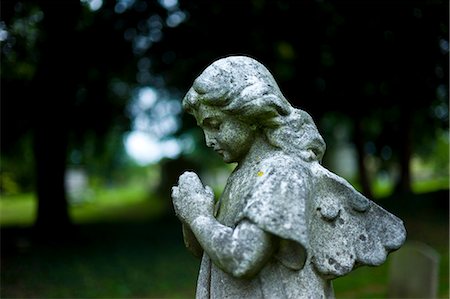 Statue of an angel in the graveyard of St Mary the Virgin Church  in Harefield, Middlesex, UK Stock Photo - Rights-Managed, Code: 841-07589887