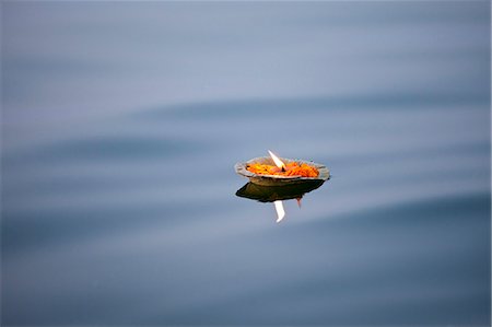 Ceremonial lit candle carries Hindu prayers on River Ganges at Varanasi, Benares, Northern India Stock Photo - Rights-Managed, Code: 841-07600068