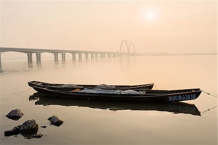 Fishing boats and modern bridge in mist at Qiantangjiang River in Hangzhou, Zhejiang, China, Asia Stock Photo - Rights-Managed, Code: 841-07782072