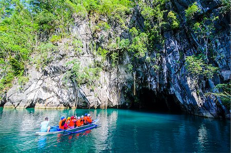 philippines landscape image - Tourists in a rowing boat entering the Puerto Princesa underground river, the New Wonder of the World, Puerto-Princesa Subterranean River National Park, UNESCO World Heritage Site, Palawan, Philippines, Southeast Asia, Asia Stock Photo - Rights-Managed, Code: 841-07782893