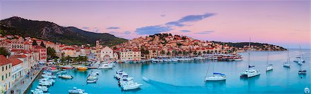 scenic and panoramic - Elevated view over the picturesque harbour town of Hvar illuminated at dusk, Hvar, Dalmatia, Croatia, Europe Stock Photo - Rights-Managed, Code: 841-08059405