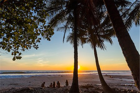 simsearch:6102-08542382,k - People by palm trees at sunset on Playa Hermosa beach, far south of the Nicoya Peninsula, Santa Teresa, Puntarenas, Costa Rica, Central America Stock Photo - Rights-Managed, Code: 841-08438859