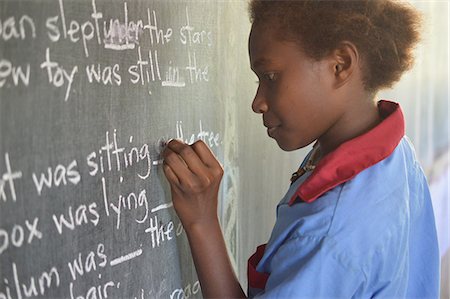 Young girl completing a gap filling exercise on a chalkboard at Malasang Primary School, Buka, Bougainville, Papua New Guinea, Pacific Stock Photo - Rights-Managed, Code: 841-08568942